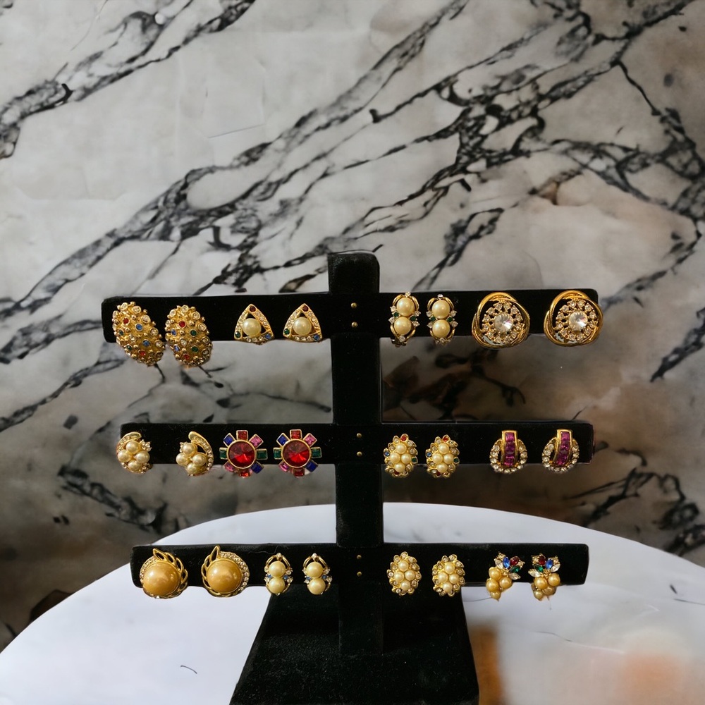 12 pairs of vintage jeweled clip on earrings.